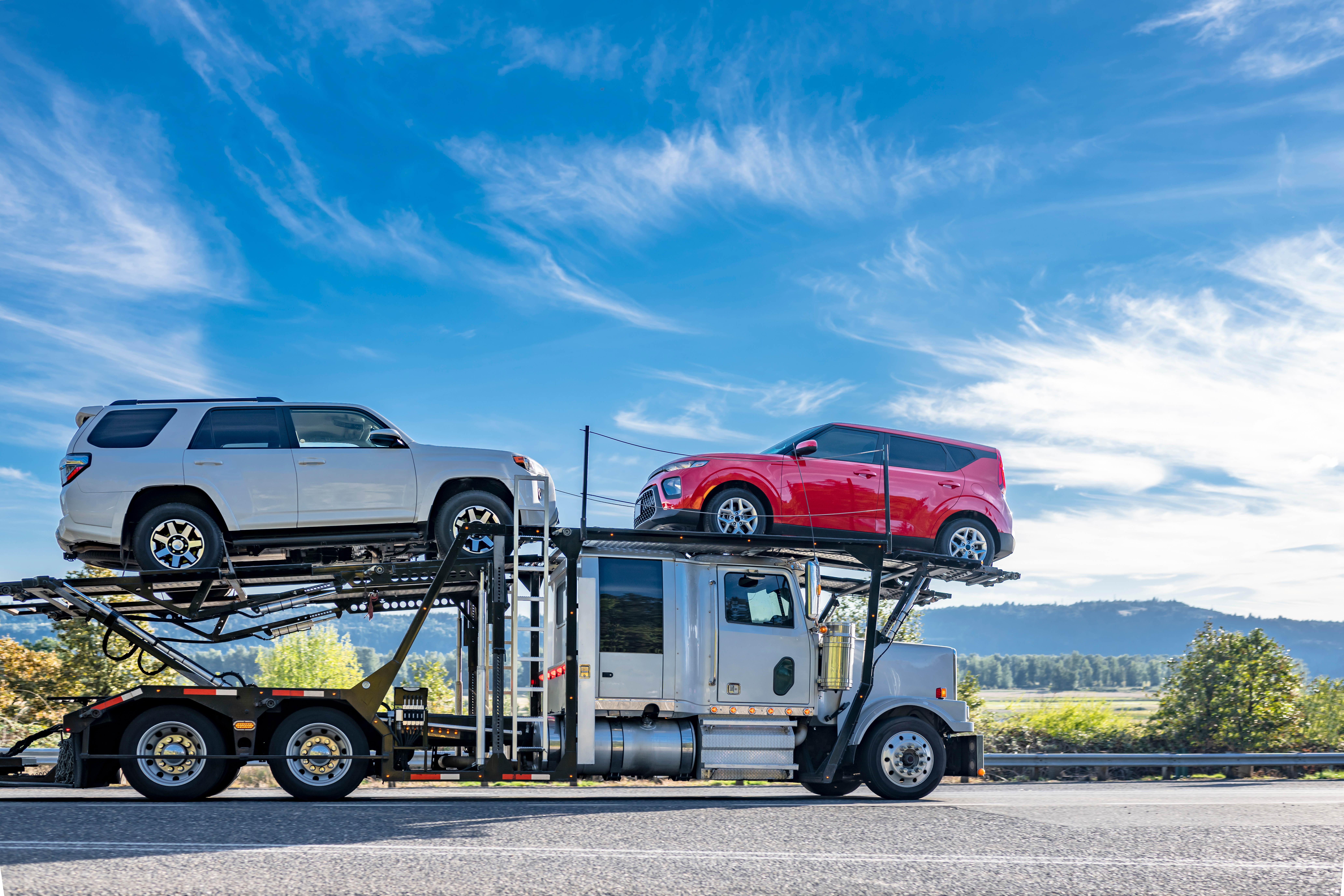 Car hauler transporting vehicles on highway